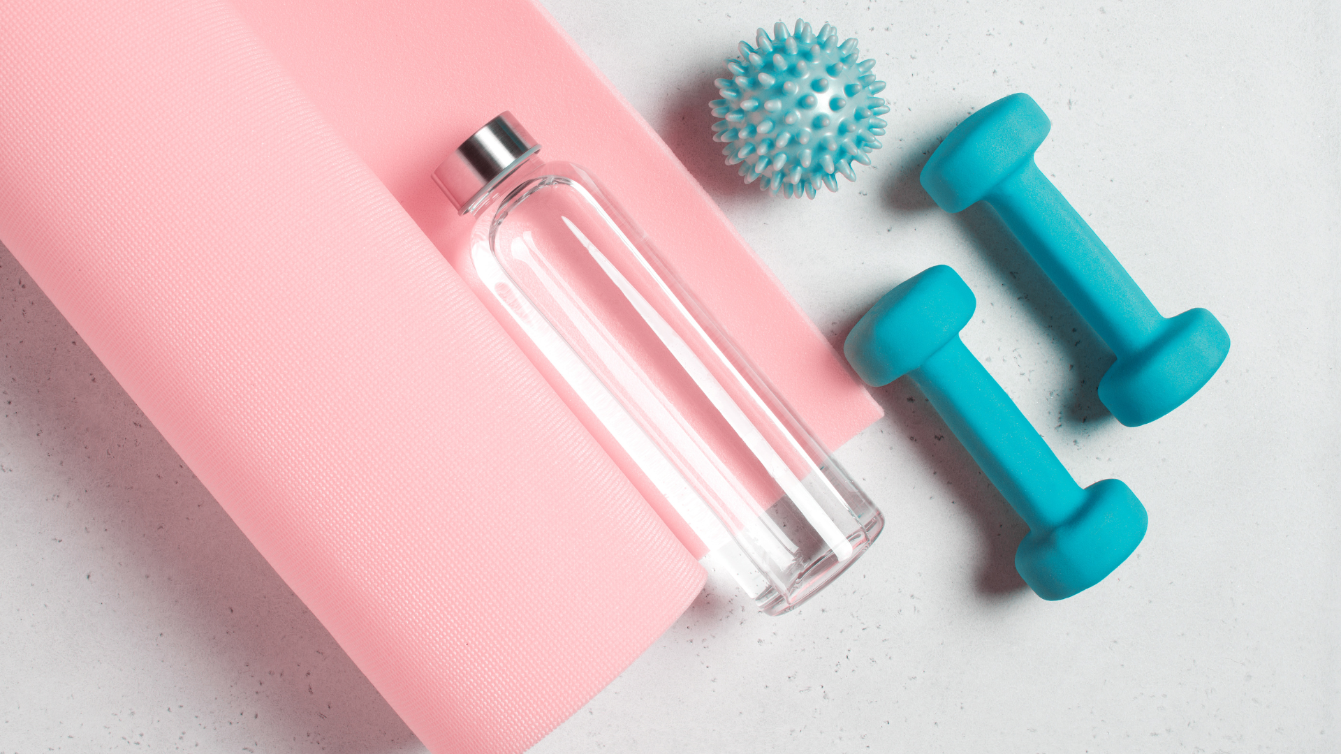 Wellness accessories including yoga mat, water bottle, dumbbells and massage ball